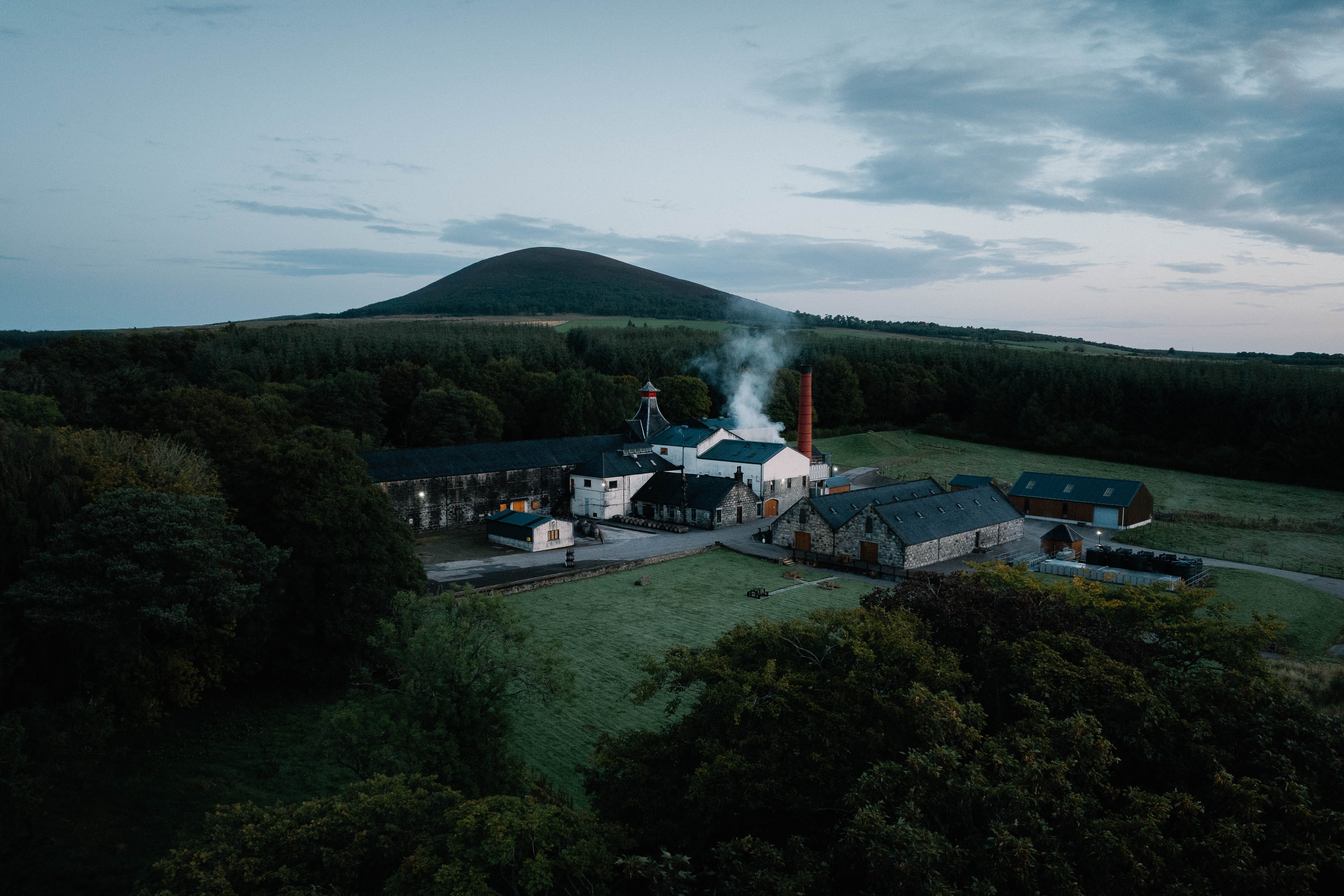 An aerial shot of a distillery nestled in the countryside